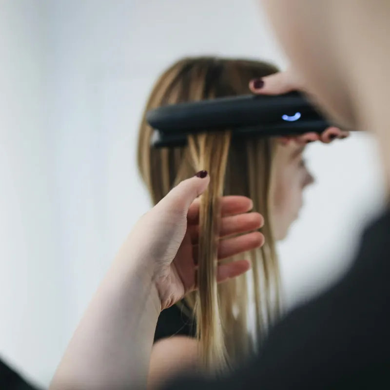 Sleek straightened hair with a glossy finish at Vibe Hair Studio